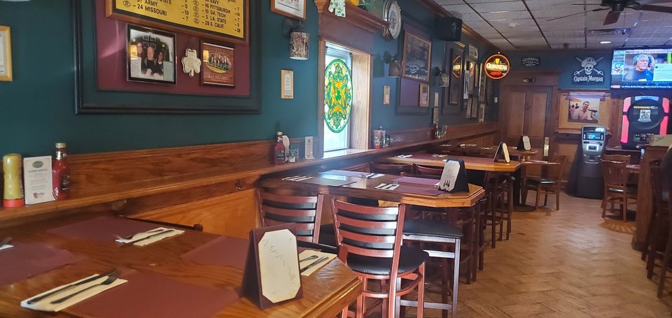 Pub tables with drinks and shared plates.